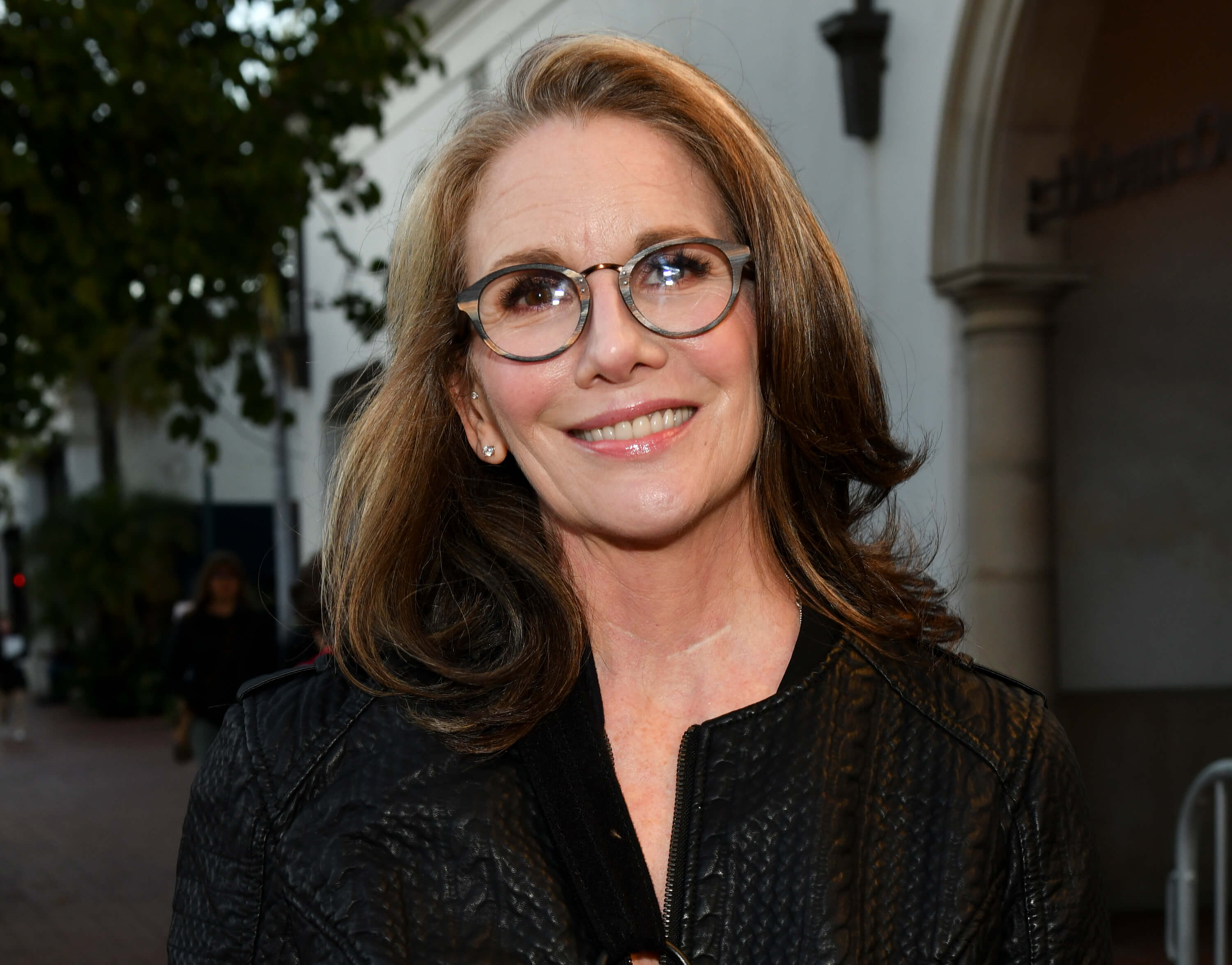 Melisa Gilbert close-up in glasses and a black shirt.