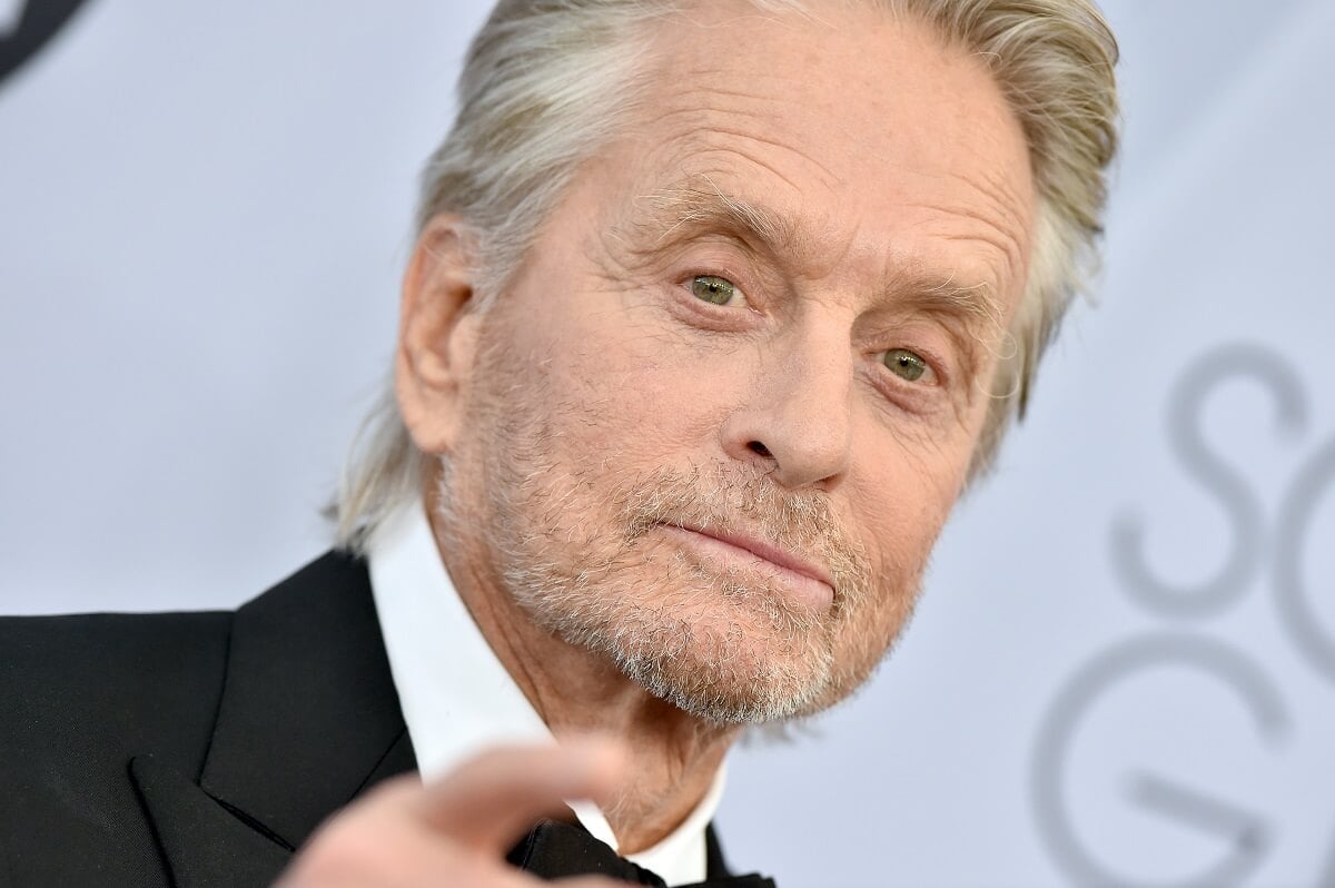 Michael Douglas posing in a suit at the 25th Annual Screen Actors Guild Awards.