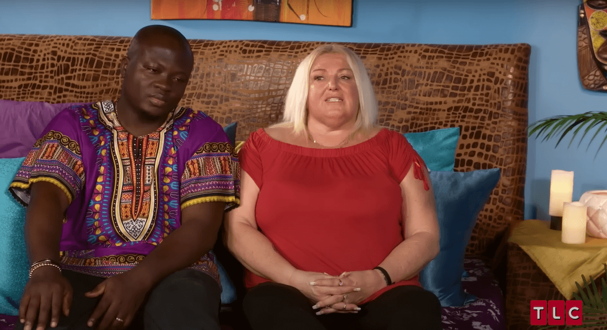 Michael Ilesanmi and Angela Deem sitting next to each other in an episode of '90 Day Fiance'
