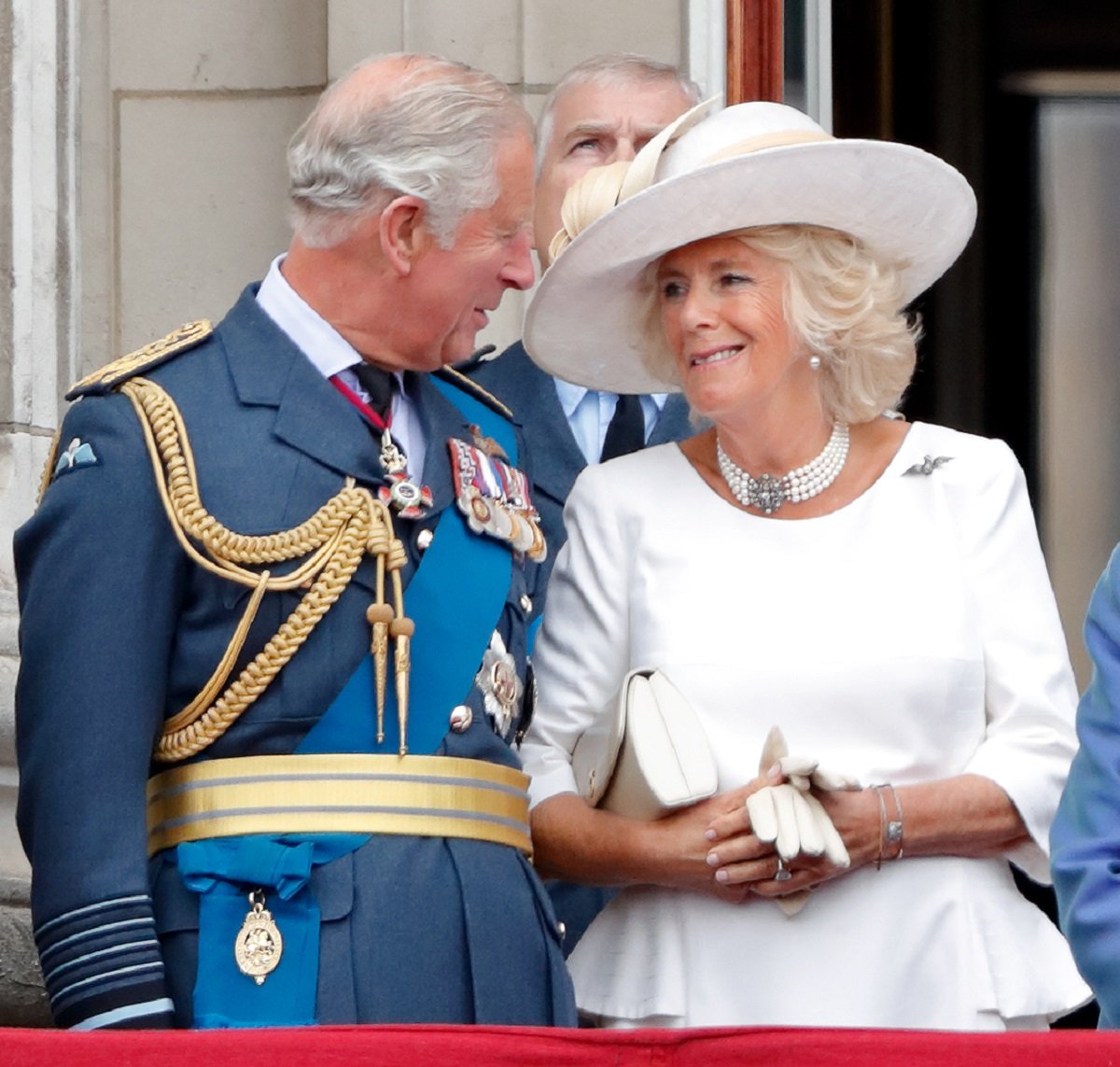 Now-King Charles III and Camilla Parker Bowles (now-Queen Camilla) standing on the balcony of Buckingham Palace prior to a flypast