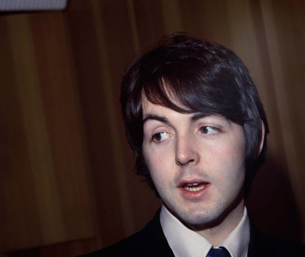 Paul McCartney looking off to his side during a 1968 press conference.