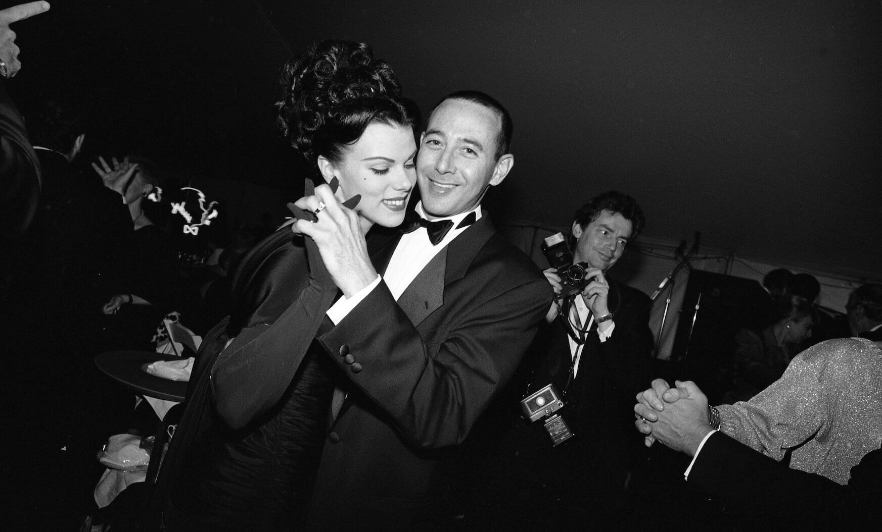 A black and white photo of Paul Reubens and Debi Mazar dancing