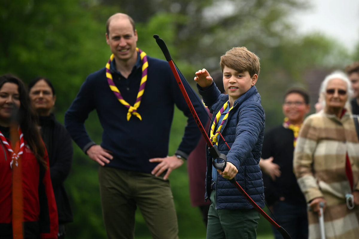 Prince George, who doesn't have the 'burden' of the line of succession, stands in front of Prince William