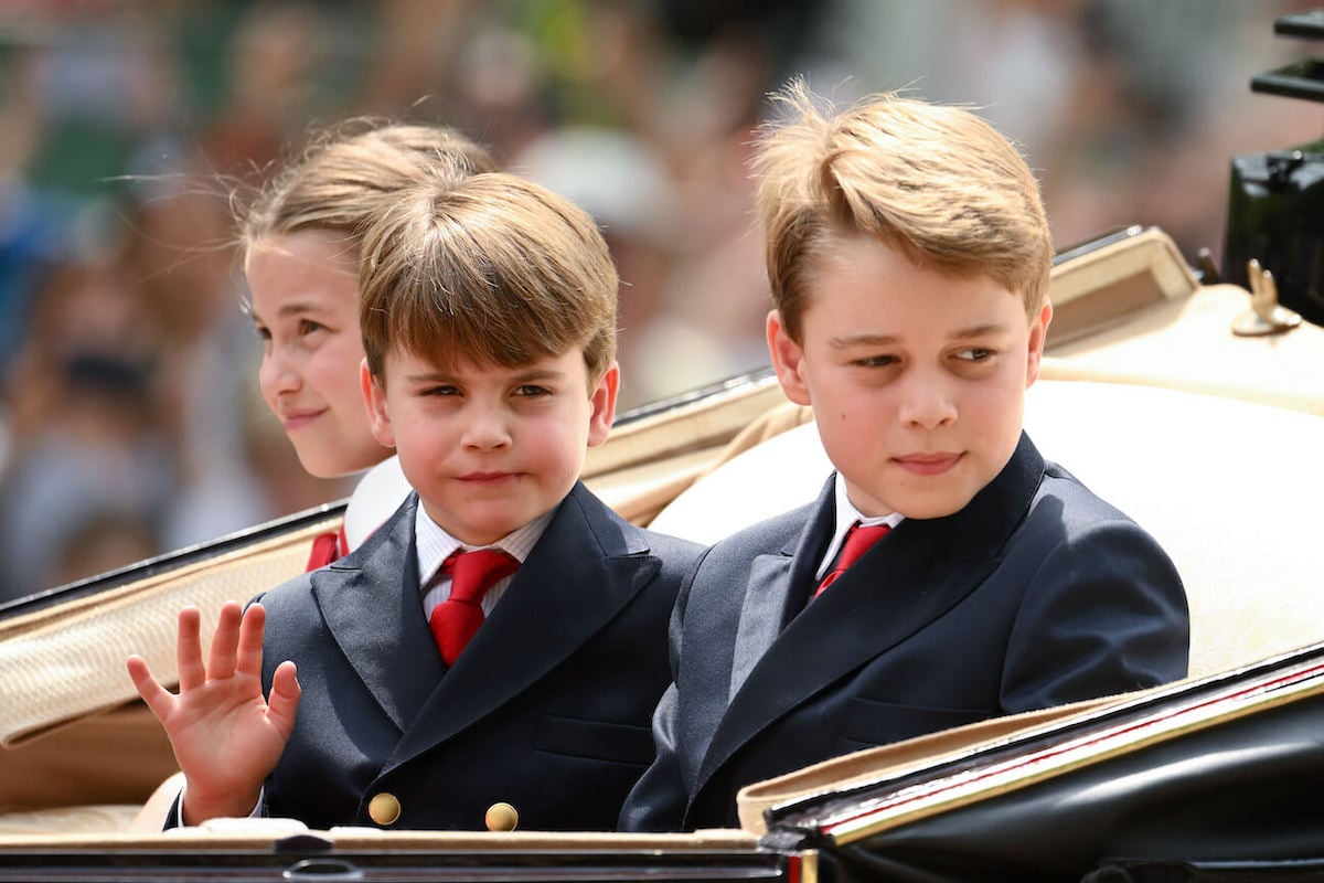 Prince George, whose potentially attending boarding school could have his siblings doing the same, sits with Princess Charlotte and Prince Louis in a carriage