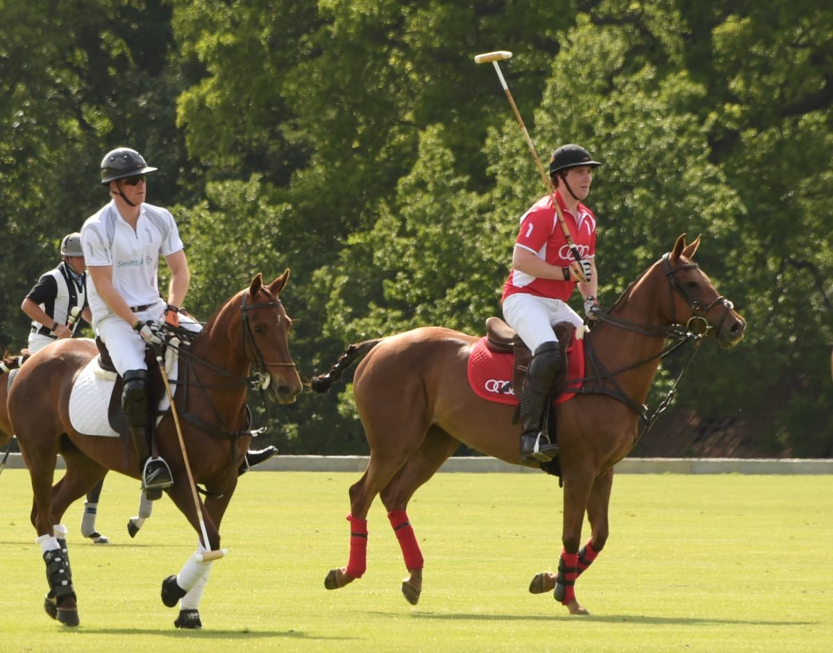 Prince Harry (L) and Jack Mann play during day one of the Audi Polo Challenge at Coworth Park