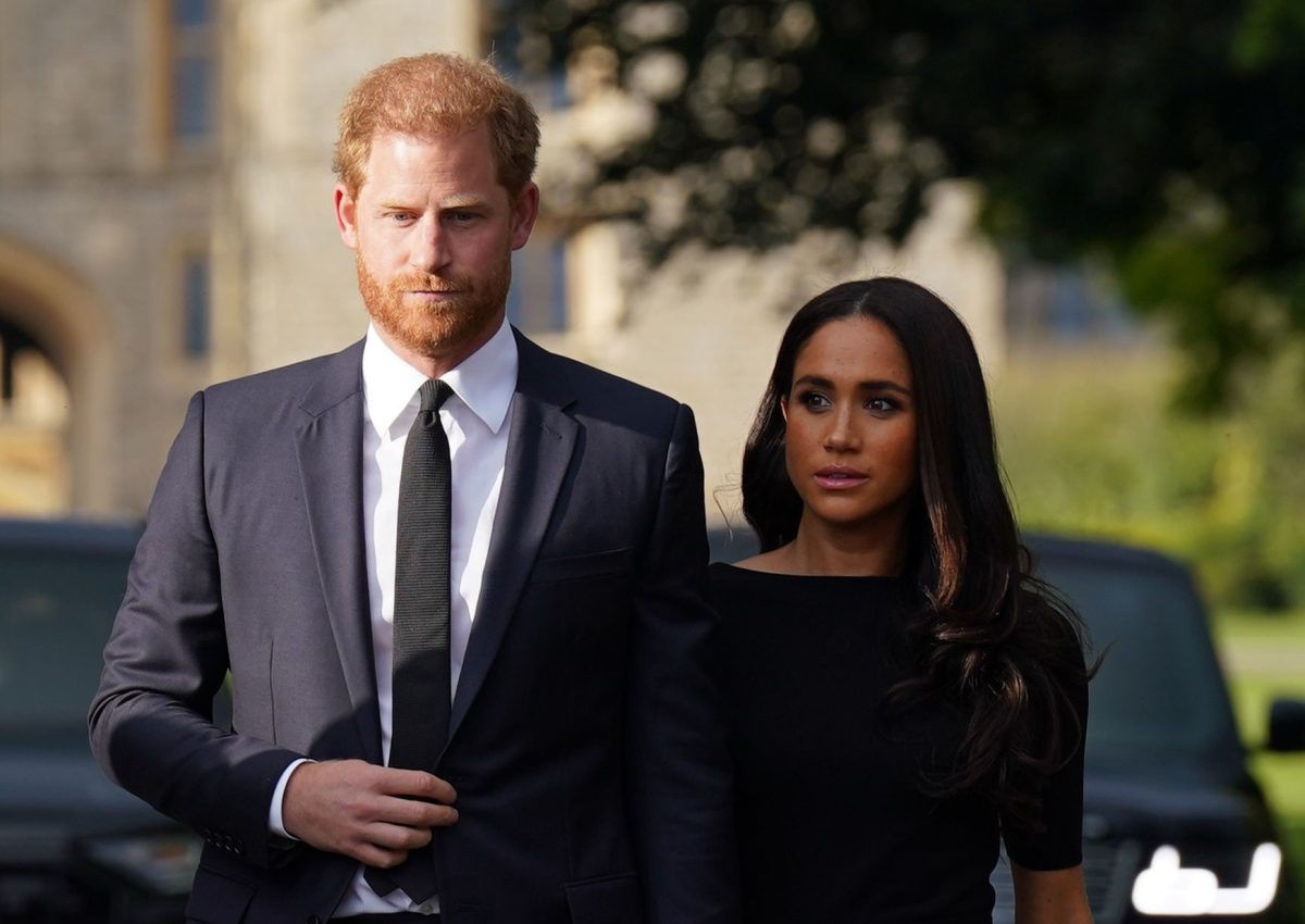 Prince Harry and Meghan Markle, who a biographer says are getting 'karma' and 'tasting the medicine' after 'damnation' of royal family, on the Long Walk at Windsor following Queen Elizabeth II's death