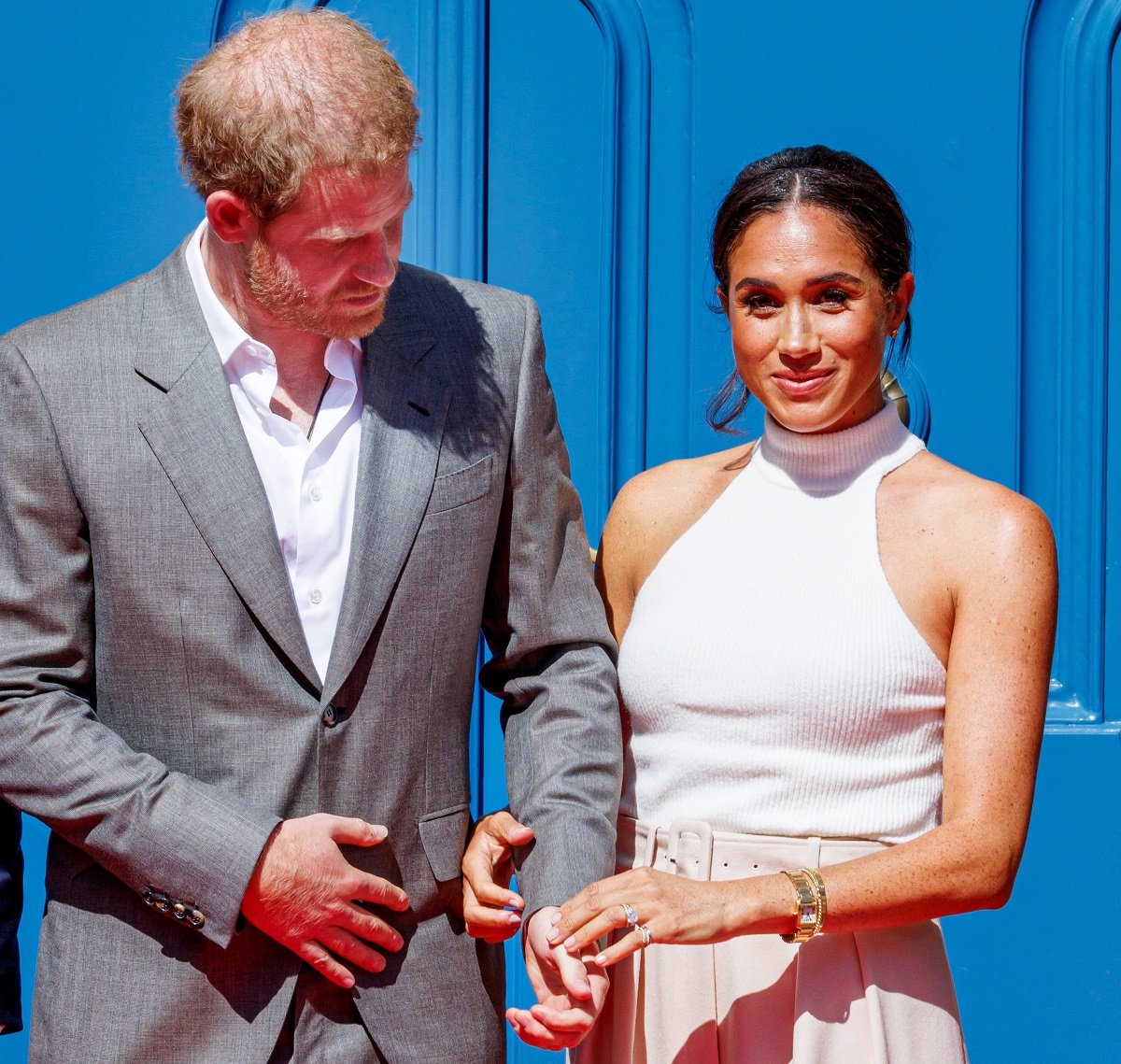 Prince Harry and Meghan Markle, who a body language expert says displayed a subtle gesture showing a change in their relationship now, visit the city hall during the Invictus Games Dusseldorf 2023