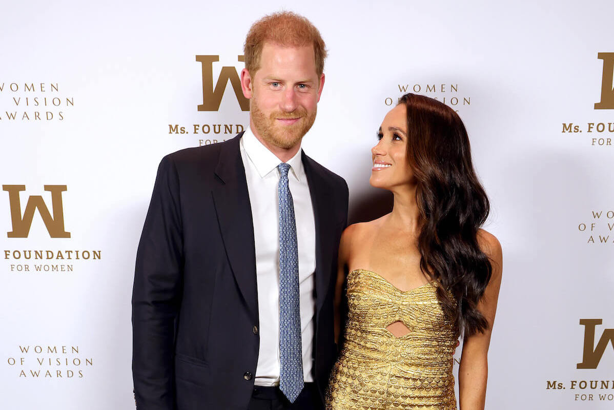 Prince Harry and Meghan Markle, who haven't answered a question about philanthropy, per an expert, pose on the red carpet