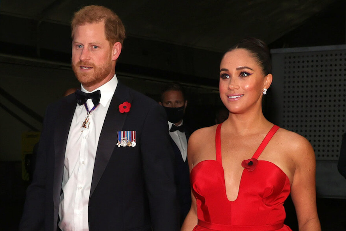 Prince Harry and Meghan Markle, whose diverging careers in Hollywood could, per a commentator, contribute to alleged 'tension' at home, hold hands