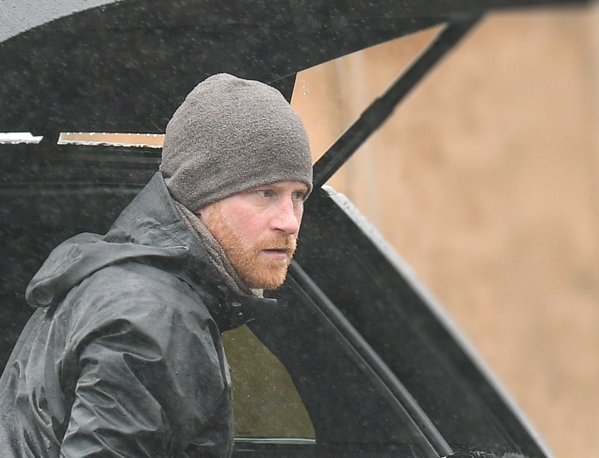 Prince Harry, who a commentator says is in no man's land after skipping real best man's wedding, is seen on a rainy day with his dog in Montecito, California