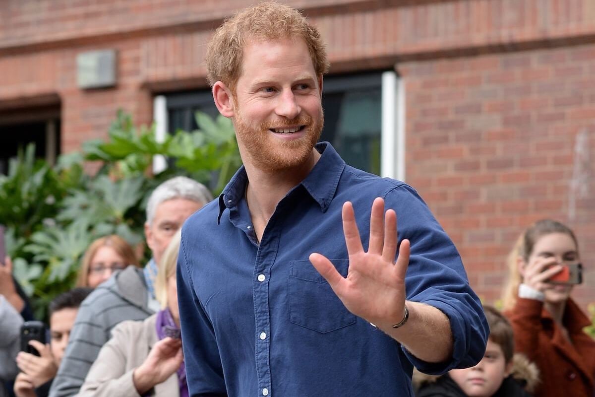 Prince Harry, who appeared 'casual' with daughter Princess Lilibet at a Fourth of July event in Montecito, California, according to a body language expert, waves wearing a blue shirt