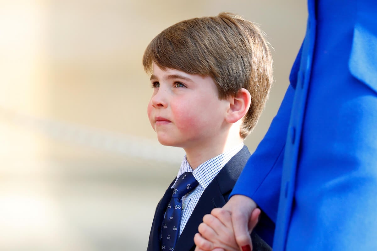 Prince Louis, who an author says will likely have the most difficult time in the 'gilded cage', looks up