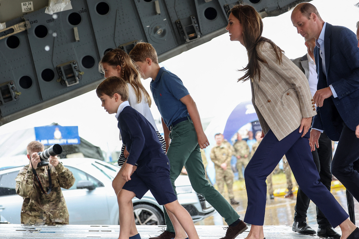 Prince William and Kate Middleton with Prince George, Princess Charlotte, and Prince Louis, who get birthday gifts like the ones Princess Diana used to gifts friends' children, walk together