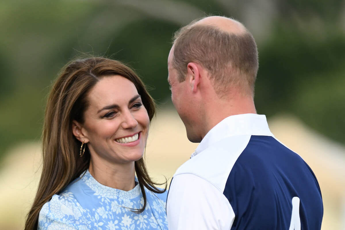 Prince William, who had apparent 'reservations' about air kissing Kate Middleton at polo match, stands with Kate Middleton