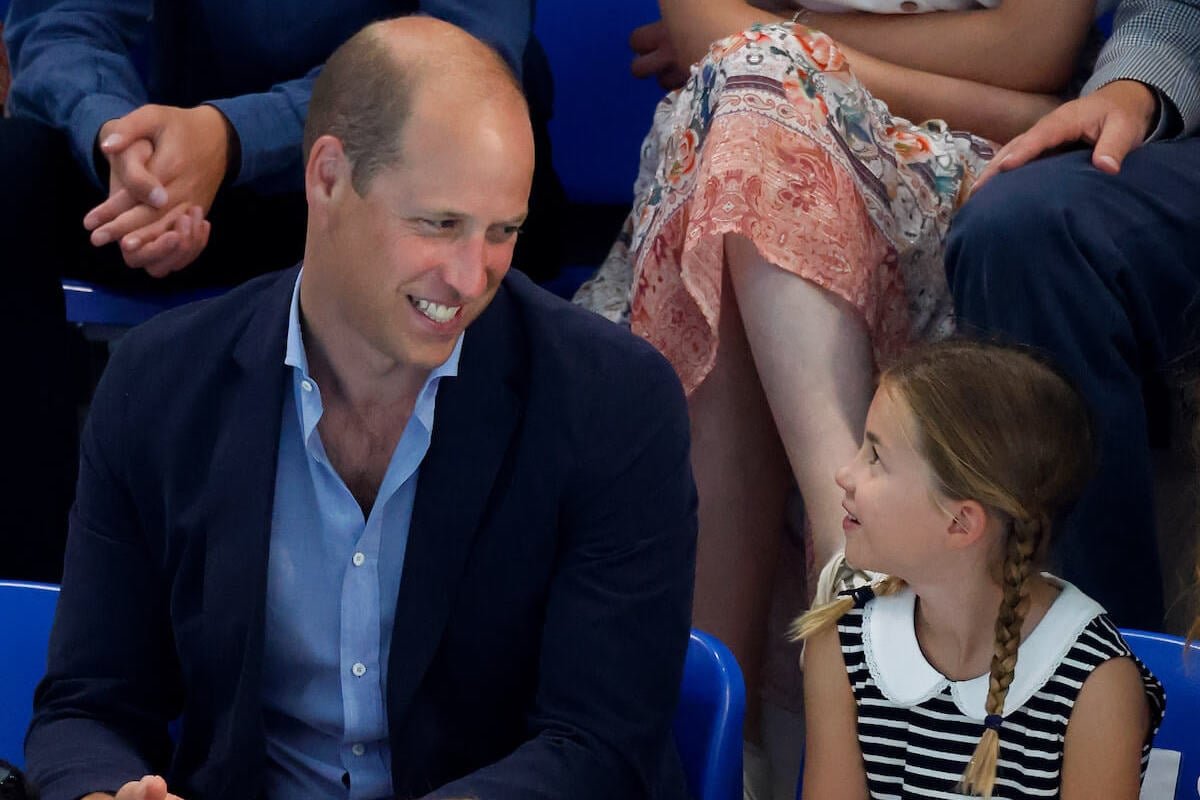 Princess Charlotte, who dropped Prince William's hand in a gesture that encapsulates their father-daughter relationship, according to a body language expert, sits with her father