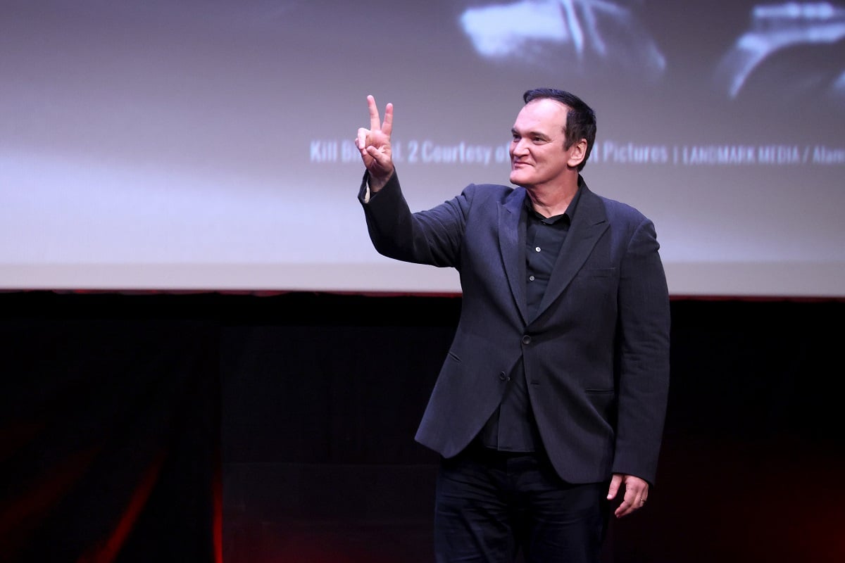 Quentin Tarantino throwing up a peace sign while attending the 16th Rome Film Fest in 2021.