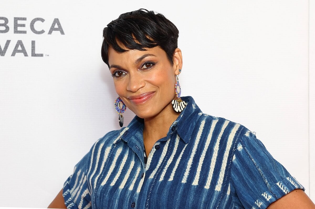 Rosario Dawson smiling in a blue outfit at the 'Common Ground' premiere.