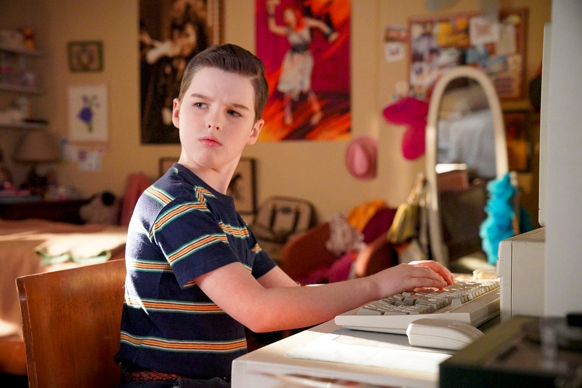 Sheldon Cooper sits in his room in an episode of 'Young Sheldon'