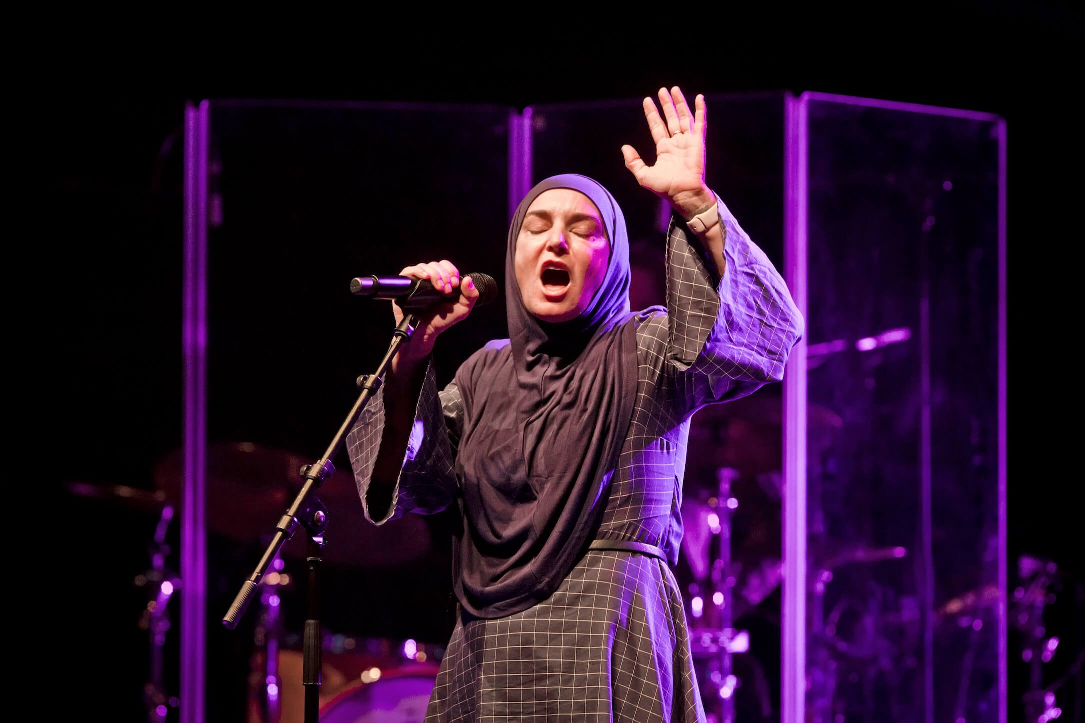 Sinead O'Connor singing into a microphone