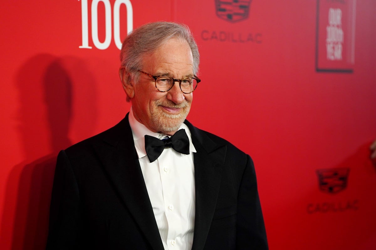 Steven Spielberg taking a picture in a suit at the 2023 TIME100 Gala.