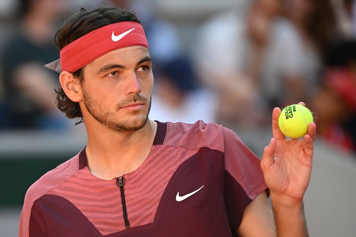 Taylor Fritz, whose ex-wife Raquel Pedraza is also the mother of his son, holding a ball during a men's singles third round match