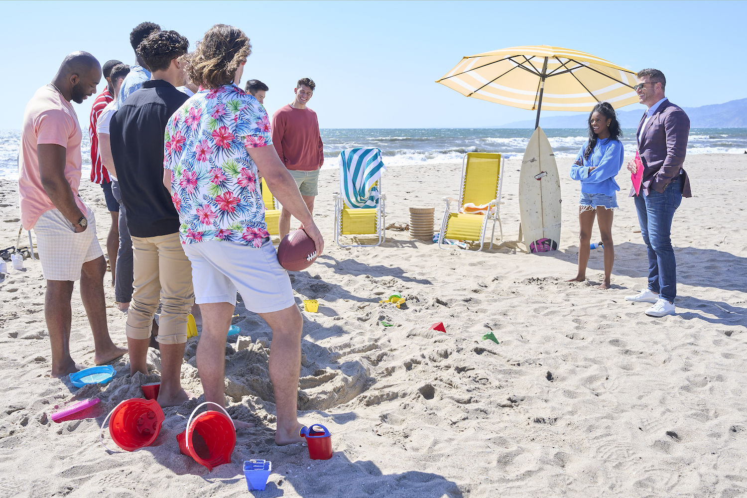 'The Bachelorette' 2023 cast members on the beach facing Charity Lawson and Jesse Palmer