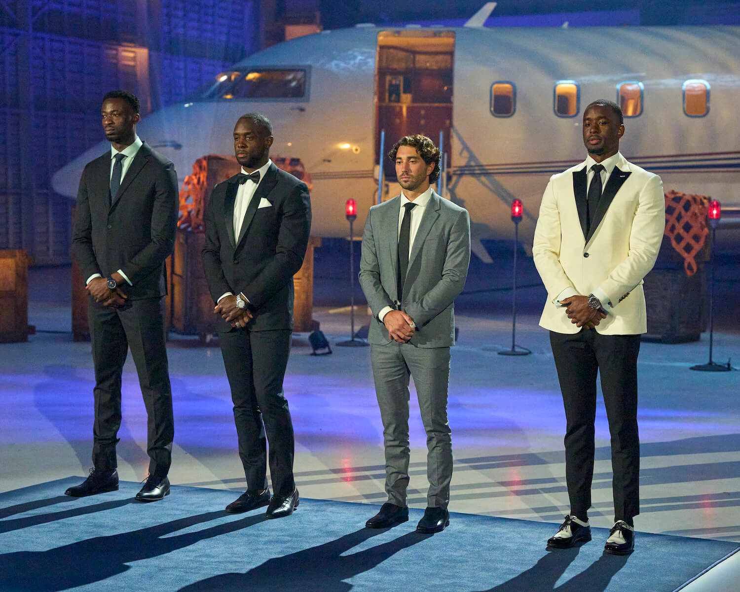 Dotun, Aaron B., Joey, and Xavier standing in a line in suits during 'The Bachelorette' 2023 hometown week