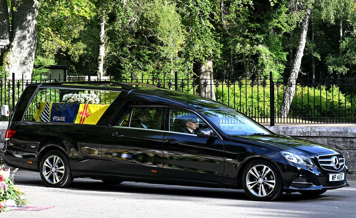 The coffin carrying Queen Elizabeth II is seen leaving Balmoral Castle on September 11, 2022 in Aberdeen, Scotland