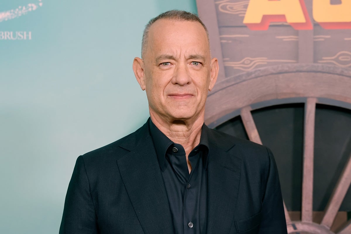 Tom Hanks posing in a suit at the premiere of 'Asteroid City'.