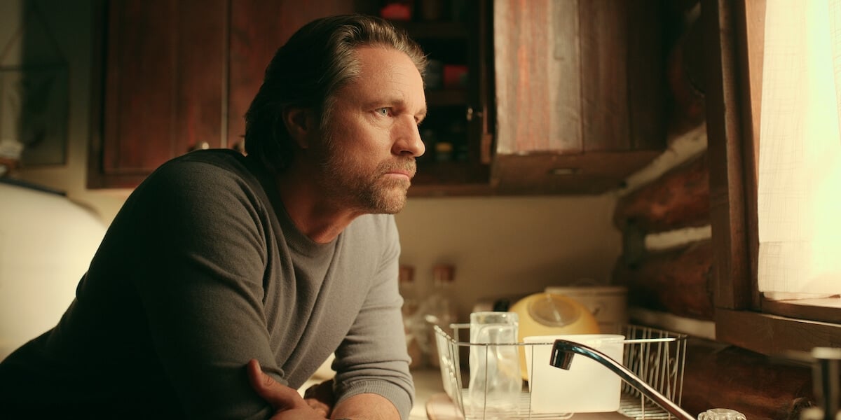 Martin Henderson in profile leaning against a sink and looking out a window in 'Virgin River' Season 5