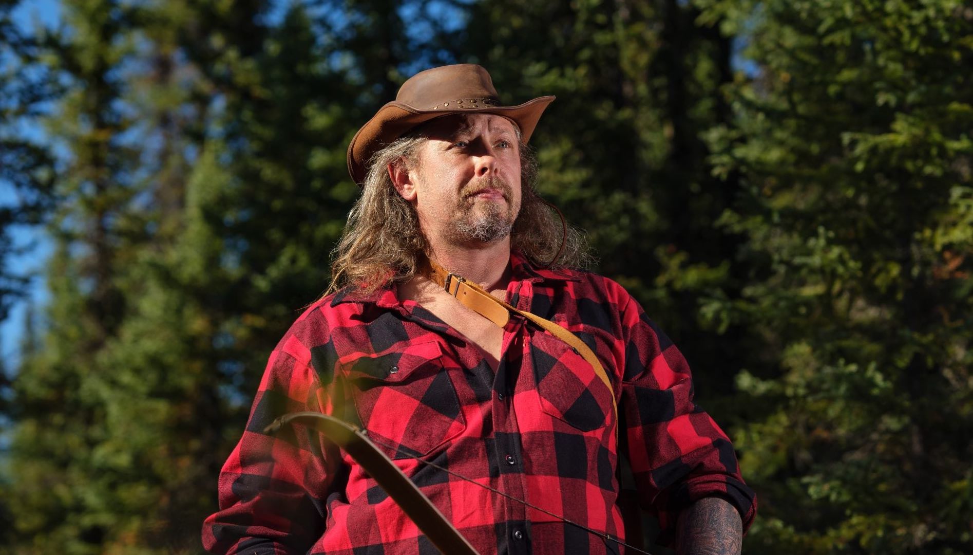 'Alone' Season 10 cast member Wyatt Black wearing a red and black checked shirt