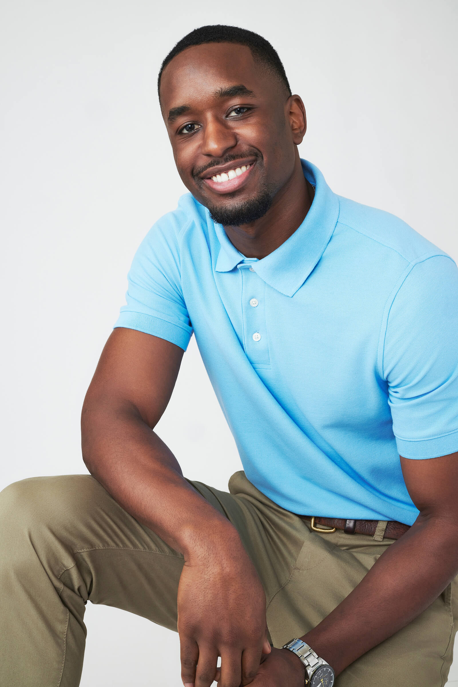 Xavier Bonner from 'The Bachelorette' 2023 wearing a blue polo and khaki pants and smiling