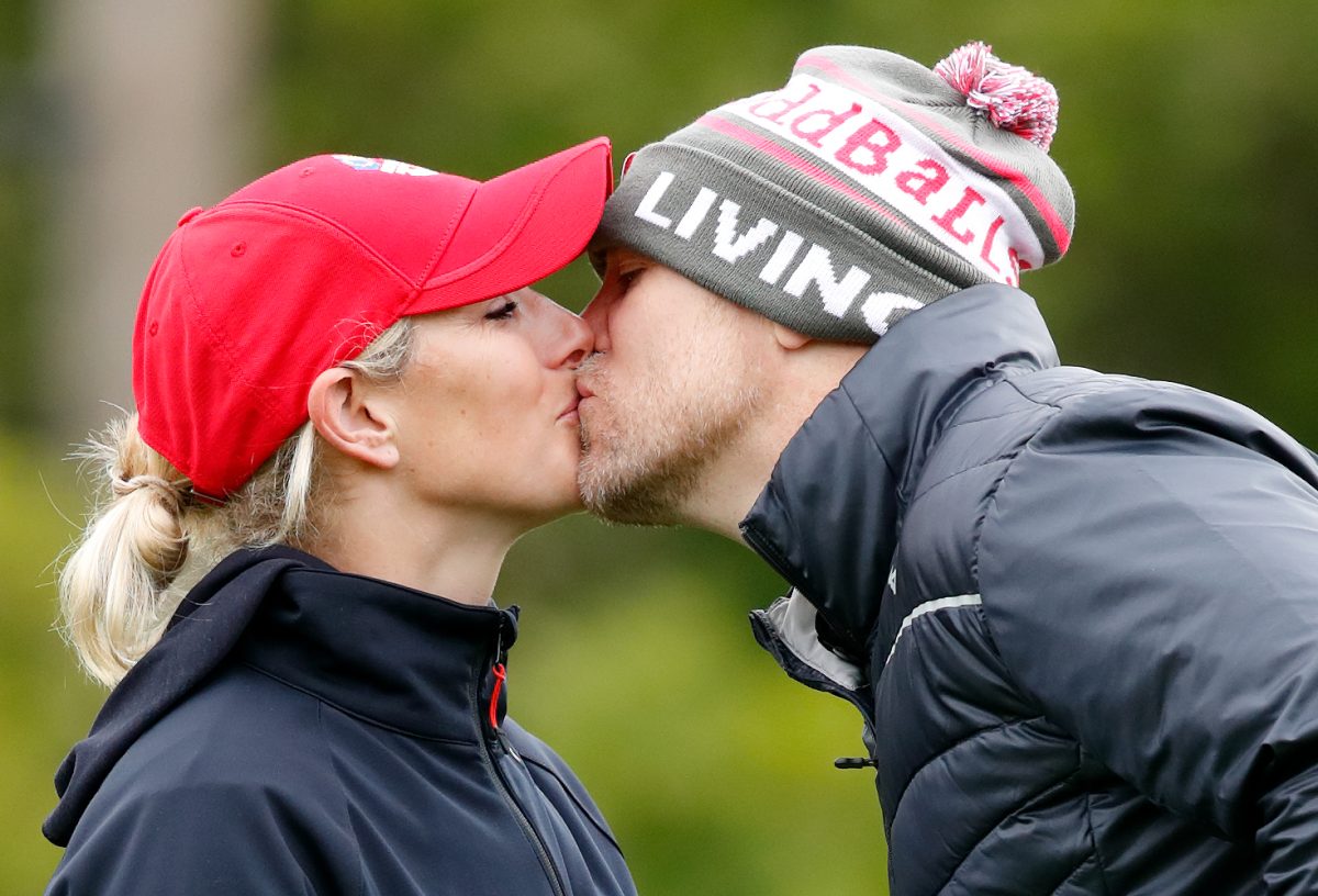 Zara Tindall and Mike Tindall kiss as they attend the ISPS Handa Mike Tindall Celebrity Golf Classic