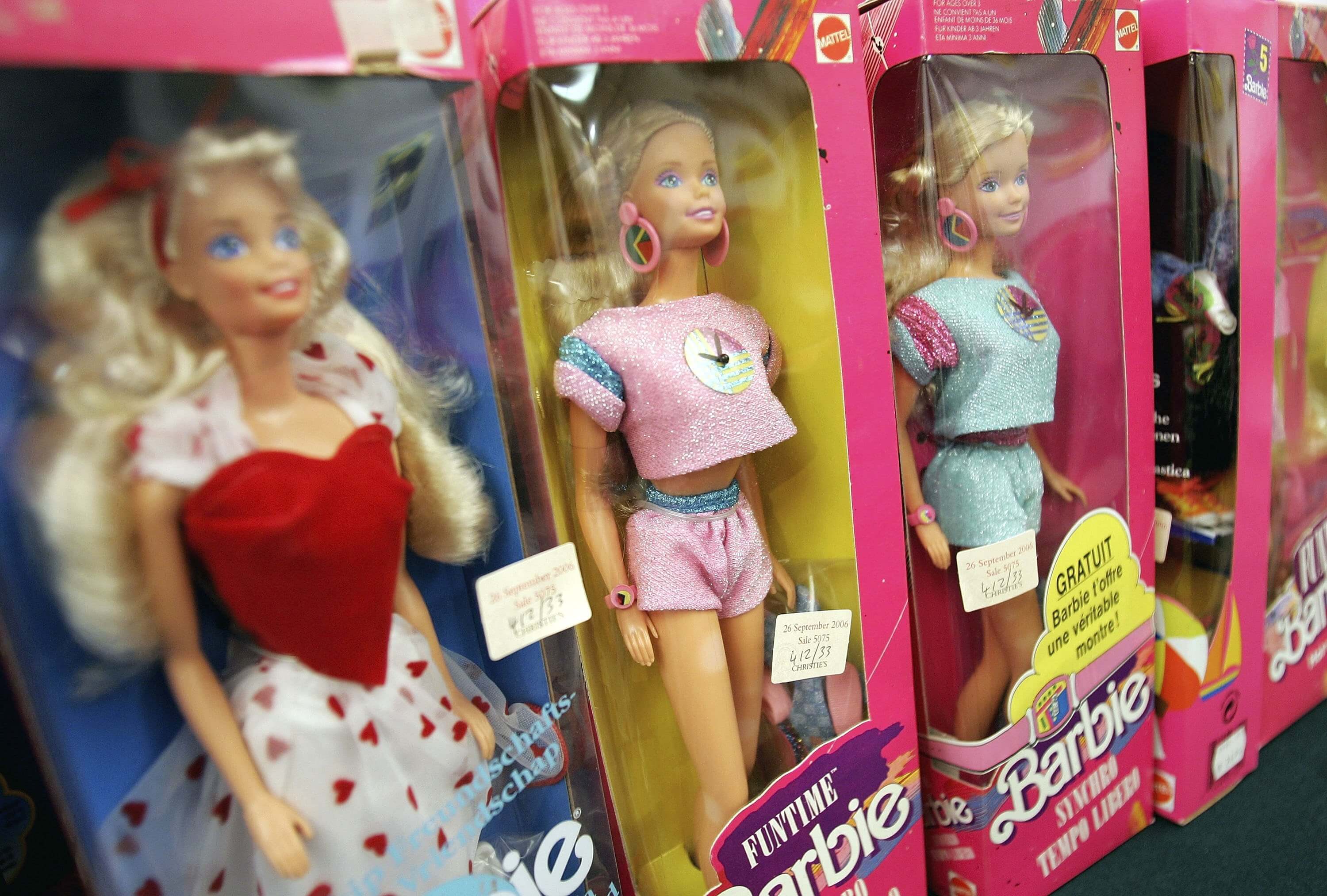 Barbies, the subject of Aqua's "Barbie Girl," in pink packaging