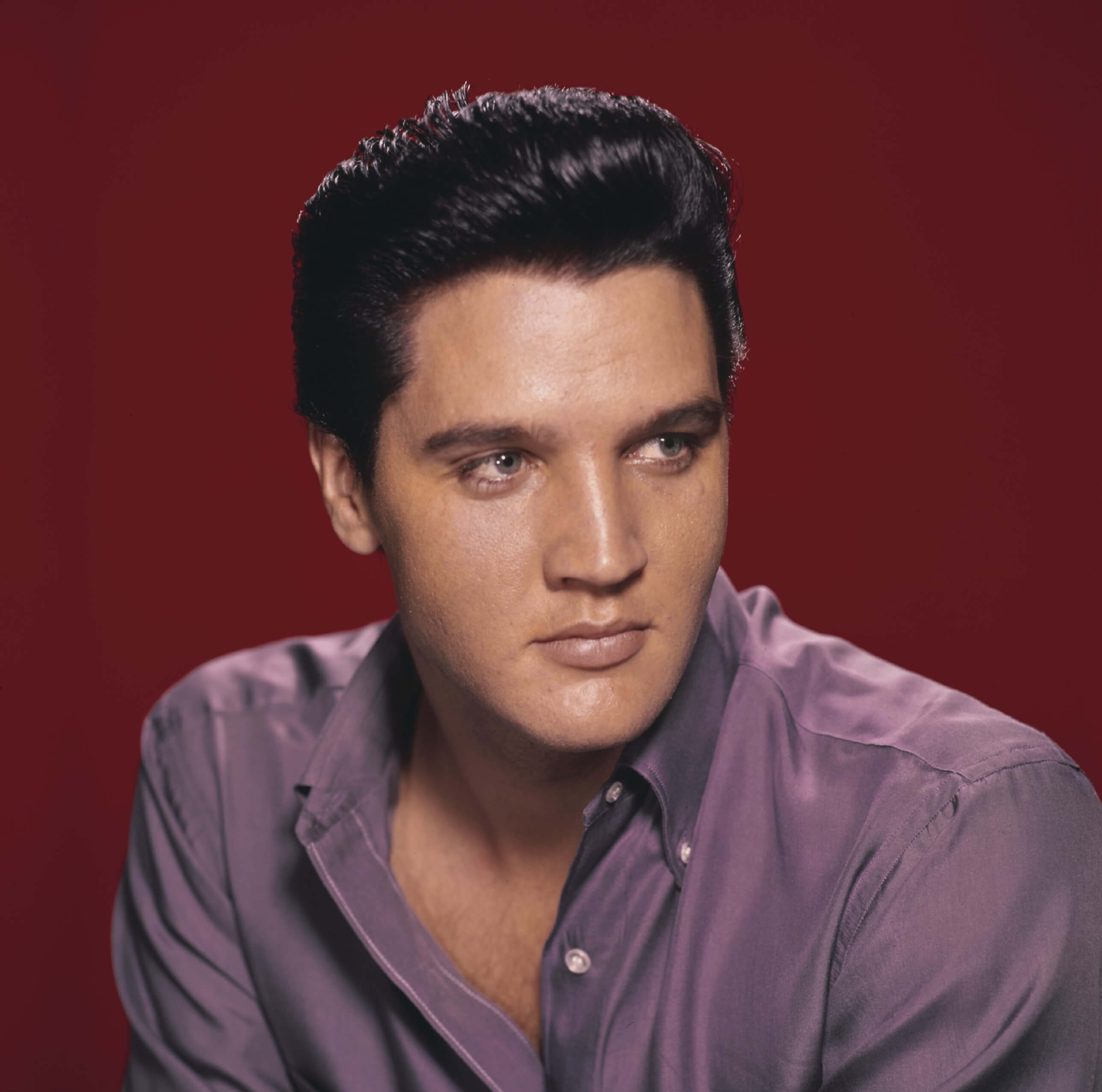 "Solitaire" singer Elvis Presley with a red background