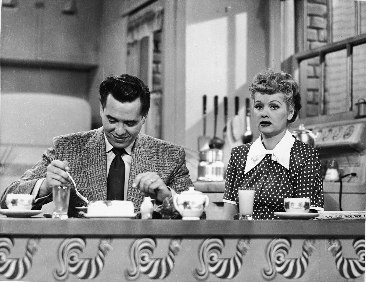 Desi Arnaz as Ricky Ricardo and Lucille Ball as Lucy Ricardo sit down for breakfast in their kitchen in 'I Love lucy'