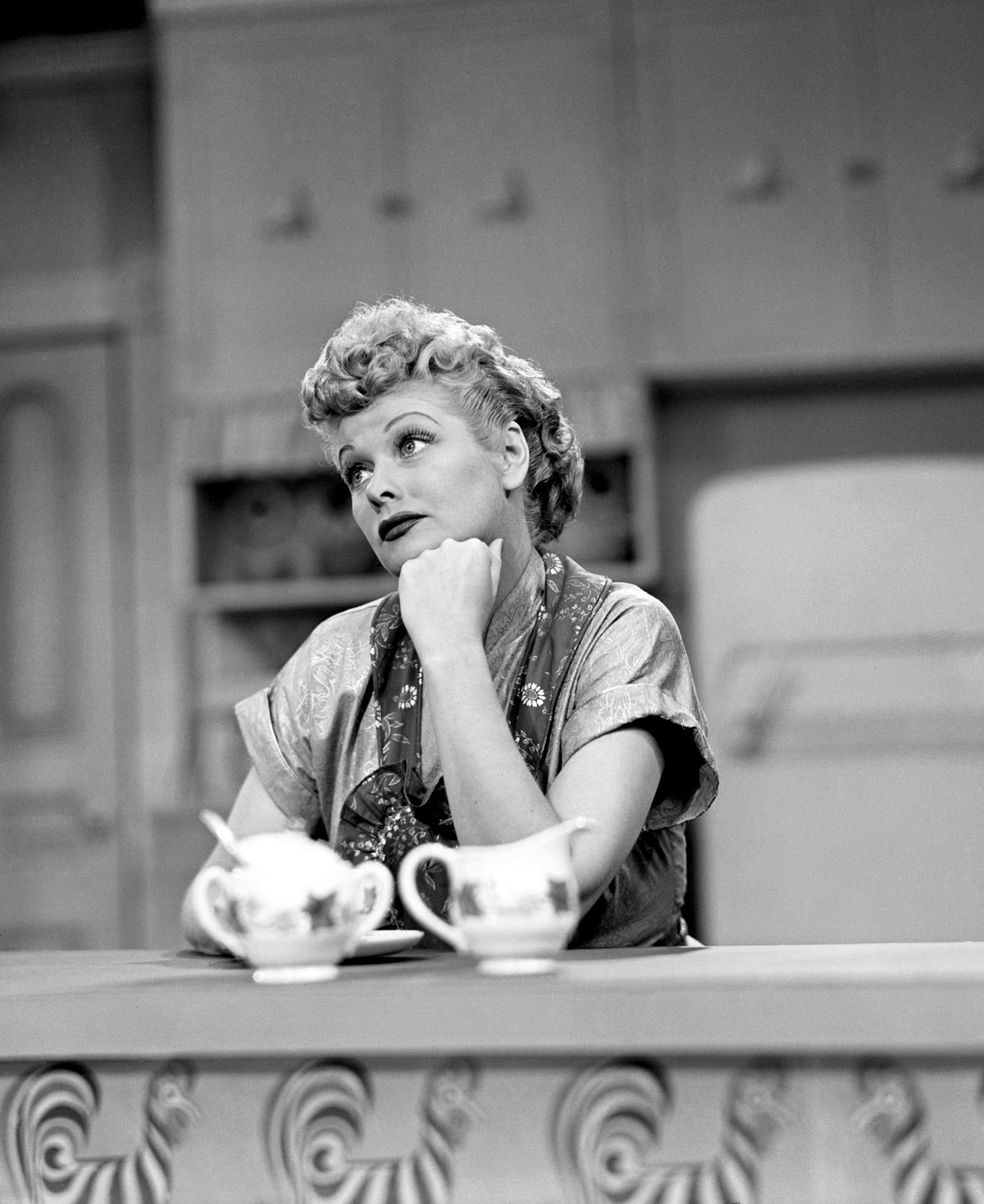 Lucille Ball sits in the kitchen on the set of 'I Love Lucy'