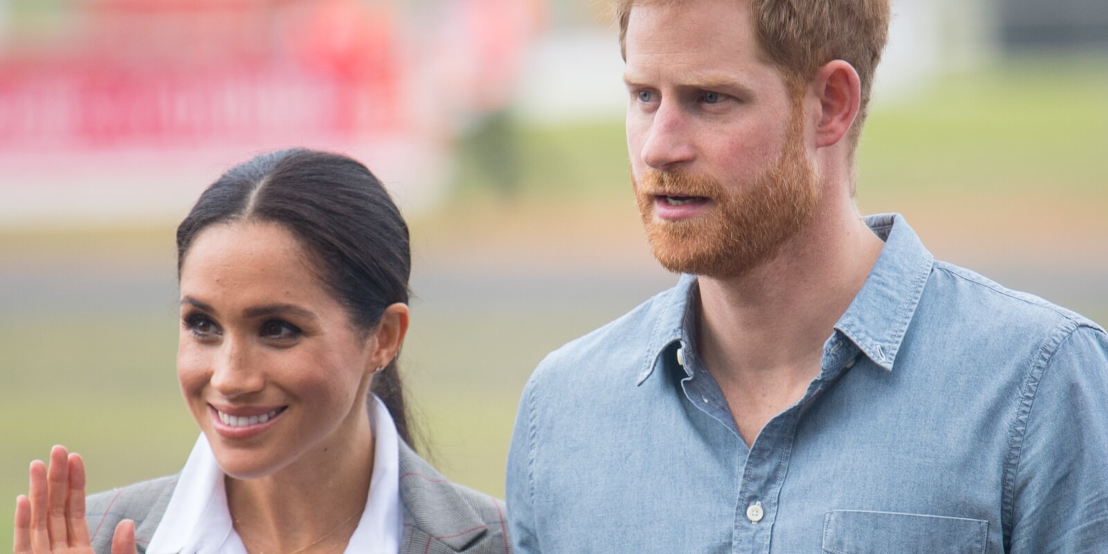 Prince Harry and Meghan Markle pose together at a naming and unveiling ceremony for the new Royal Flying Doctor Service aircraft at Dubbo Airport on October 17, 2018 in Dubbo, Australia.
