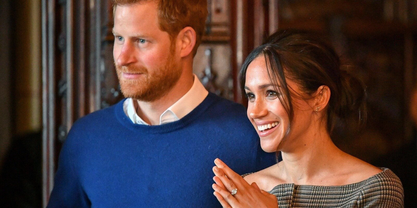 Prince Harry and Meghan Markle are photographed as they watch a performance by a Welsh choir in the banqueting hall during a visit to Cardiff Castle on January 18, 2018 in Cardiff, Wales.