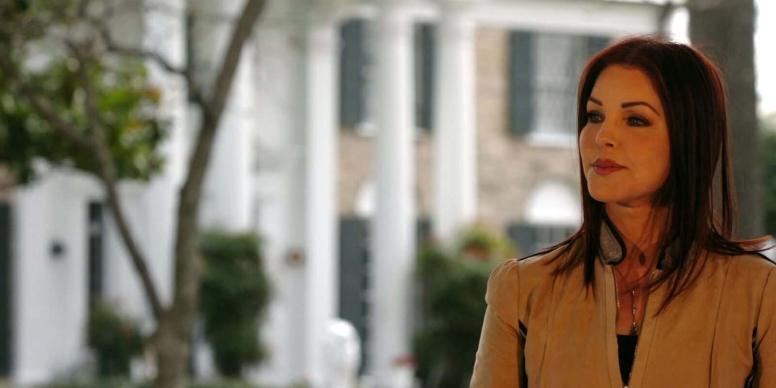 Priscilla Presley poses outside of Elvis Presley's Graceland home in Memphis, TN on March 27, 2006.