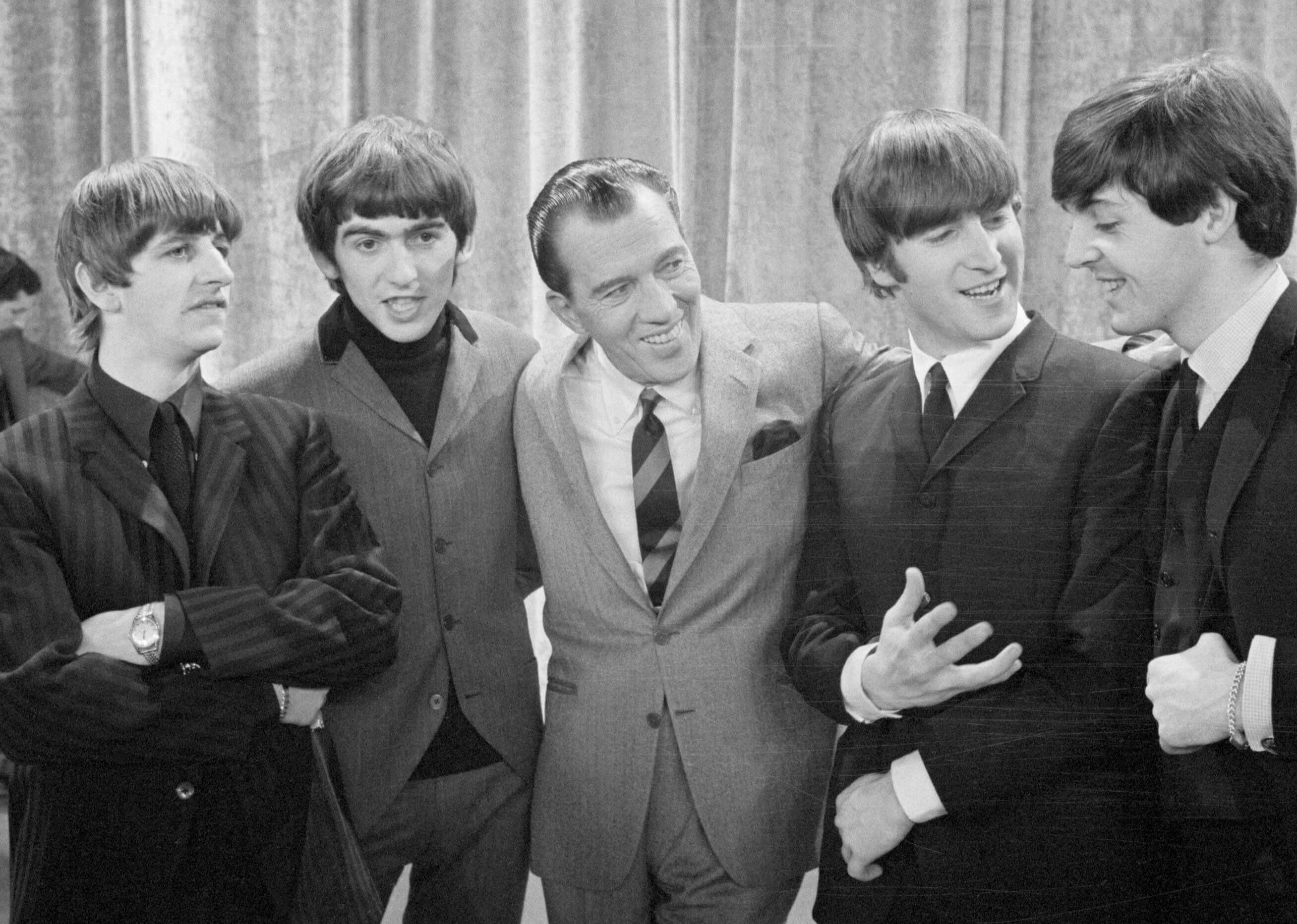 The Beatles and Ed Sullivan in black-and-white