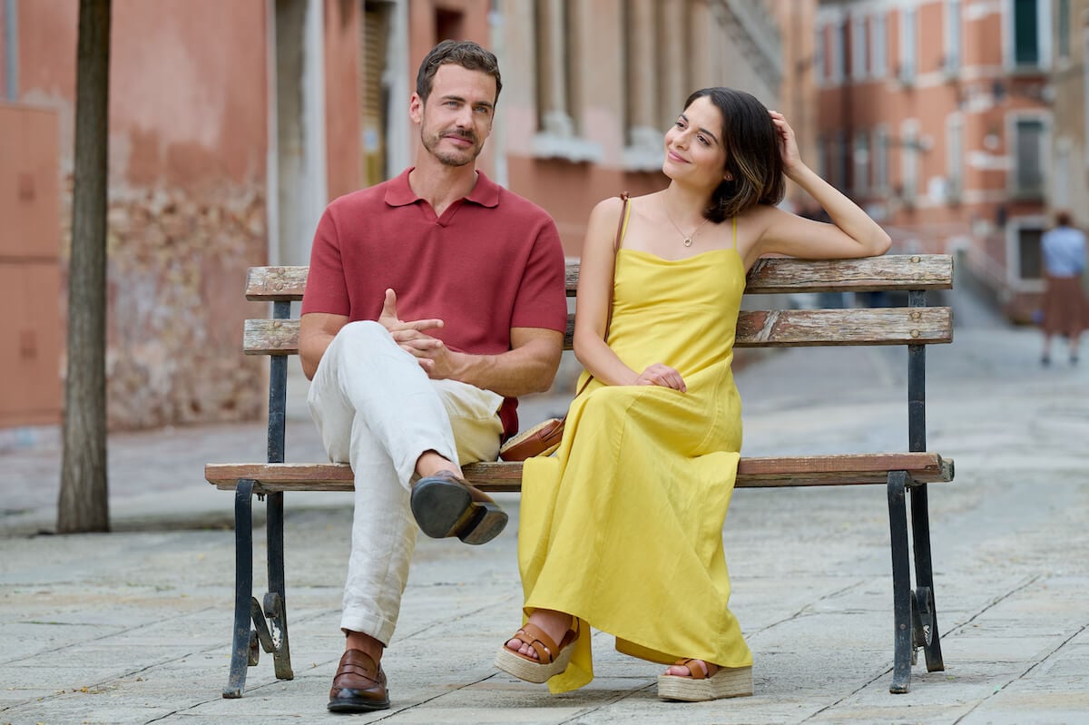 Couple sitting on a bench in 'A Very Venice Romance'