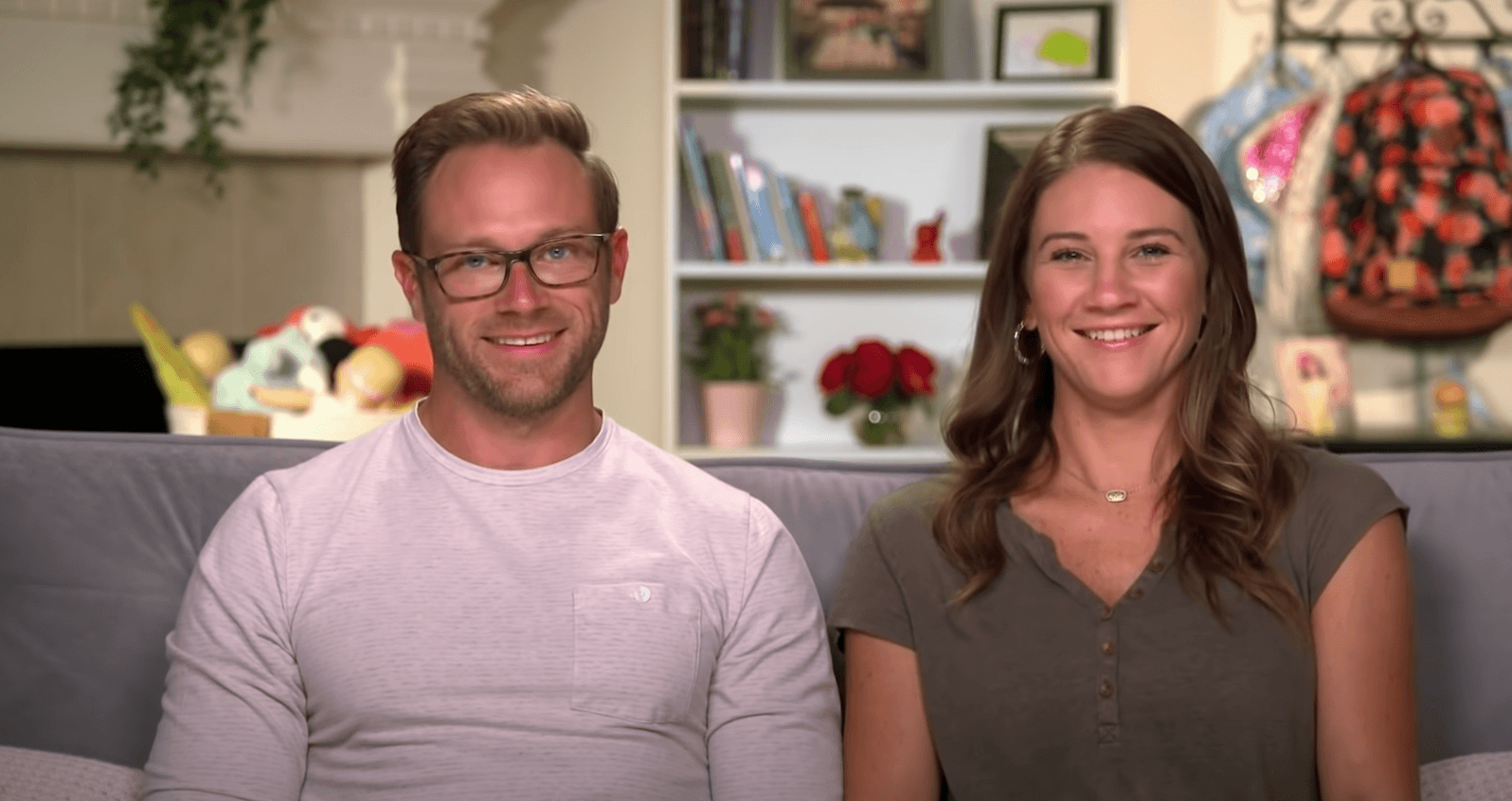 Adam and Danielle Busby sitting on a couch in 'OutDaughtered'