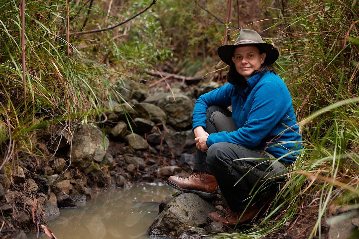 'Alone Australia' cast member Kate Grarock posing by a stream