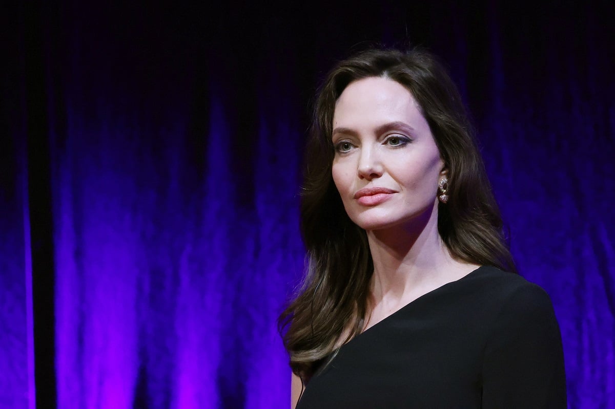 Angelina Jolie attending the 'Eternals' press conference while wearing a black dress.