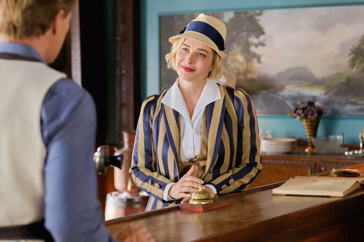 Madeline, wearing a hat and striped jacket, looking at Bill in 'When Calls the Heart' Season 10