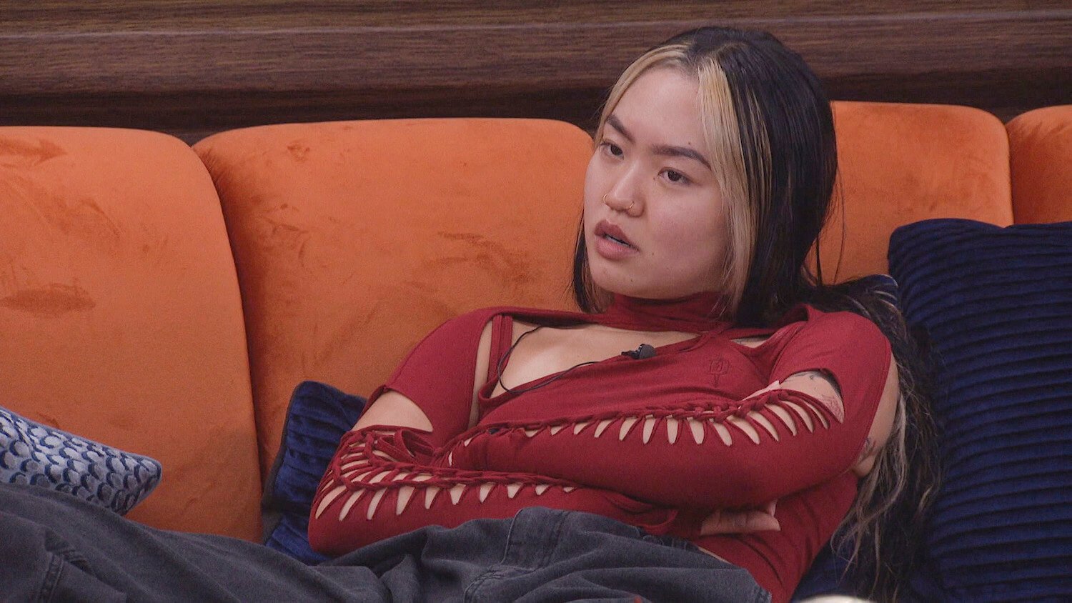 Blue Kim from 'Big Brother' Season 25 crossing her arms while sitting on a couch