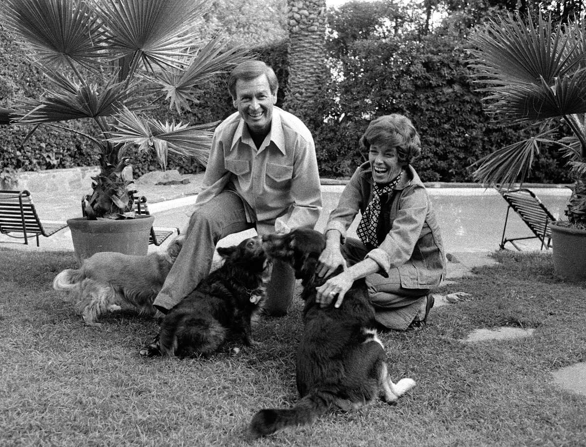 Bob Barker and his wife, Dorothy Jo Gideo, play with their dogs in 1977