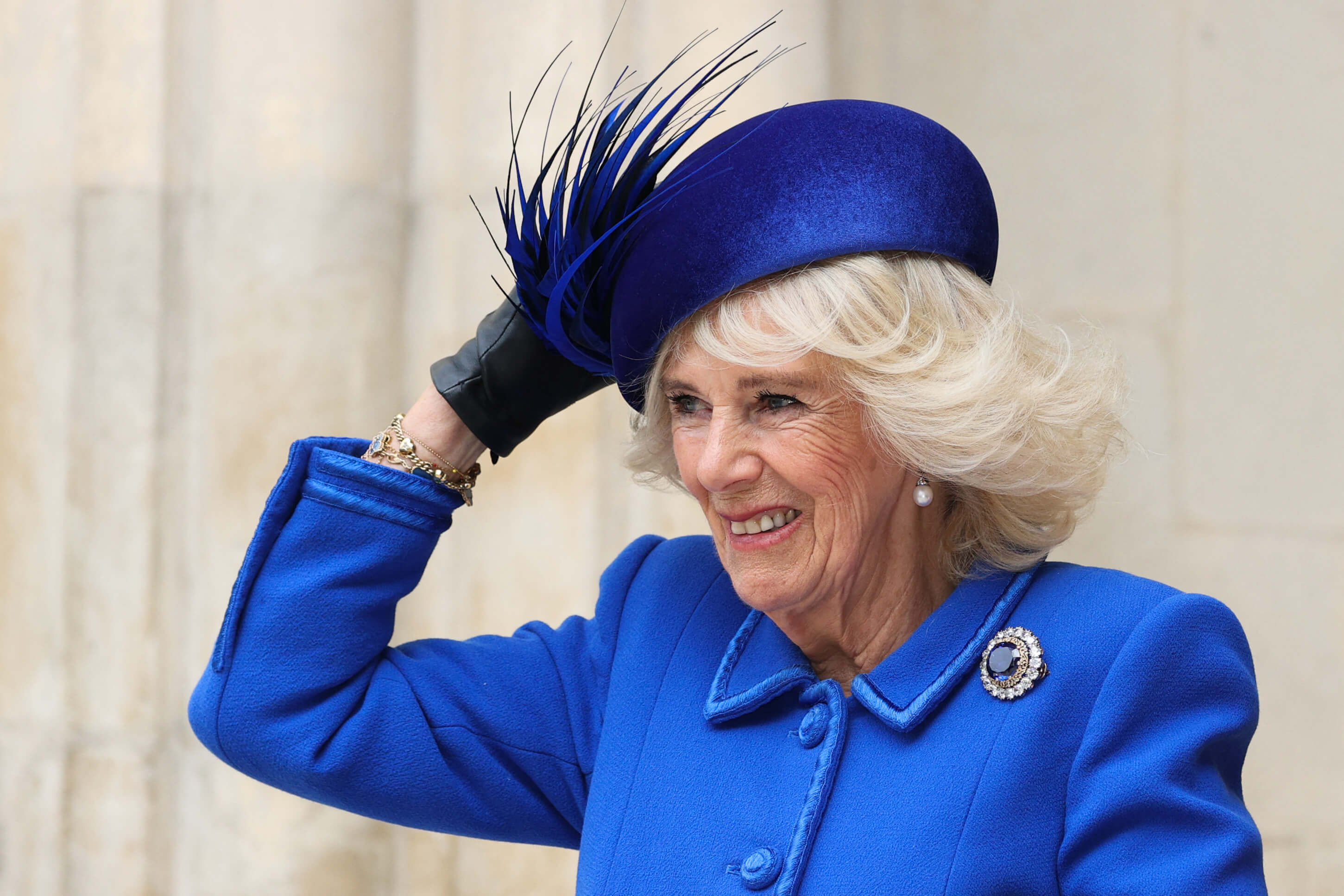 Camilla Parker Bowles (now-Queen Camilla) holds her hat as she arrives to attend 2023 Commonwealth Day service