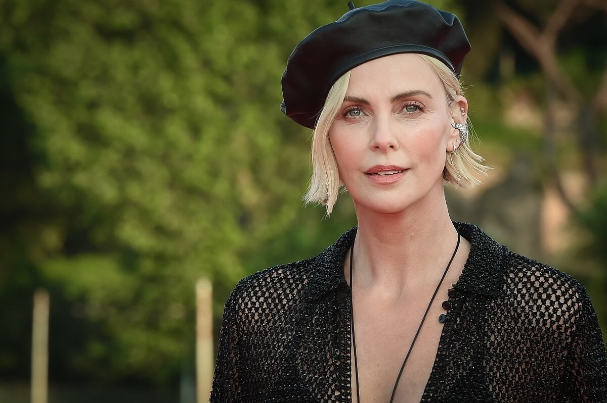 Charlize Theron wearing a black outfit and hat at the red carpet at the world premiere of the film Fast X